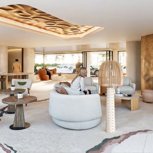 A modern lounge with stylish furniture, art, and a fireplace. Neutral tones and elegant design create a welcoming atmosphere.