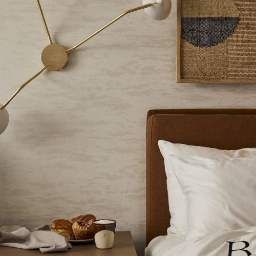 A cozy bedroom scene with a bedside table, a hanging plant, and a wooden headboard with a neatly made bed, soft lighting, and a calm vibe.